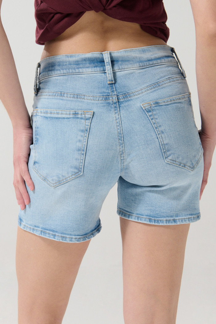 Short tiro medio azul en jean con desgastes localizados