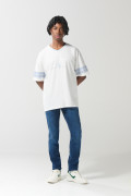 Camiseta crema cuello V con diseño college oversize