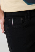 Jean skinny ajustado negro con cremallera y tiro bajo