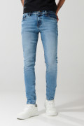 Jean skinny ajustado azul medio con desgastes y tiro bajo