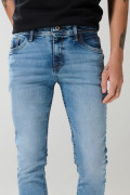 Jean skinny ajustado azul medio con desgastes y tiro bajo