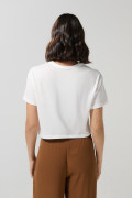 Camiseta crema clara crop top con diseño de E.T.