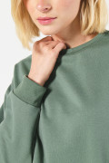 Buzo unicolor cuello redondo oversize con hombro caído