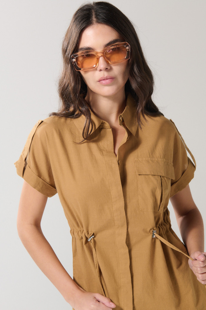 Blusa café clara con manga corta, charreteras y bolsillo